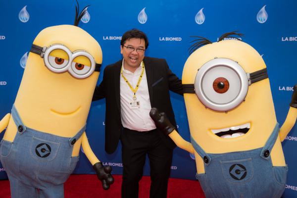 Attendee and minion characters in front of LA Biomed backdrop at Spirit of Innovation Gala 2018