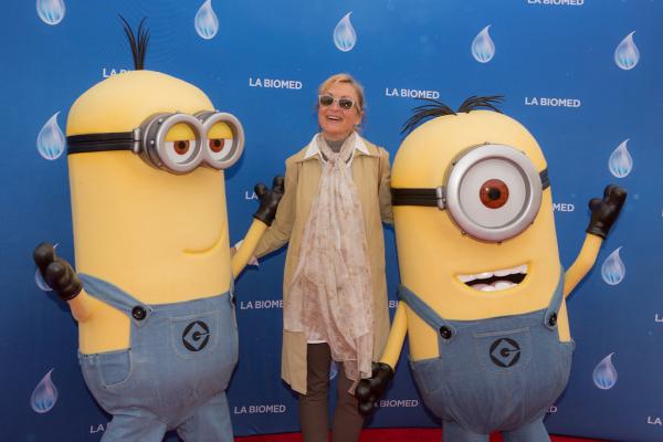 Attendee and minion characters in front of LA Biomed backdrop at Spirit of Innovation Gala 2018