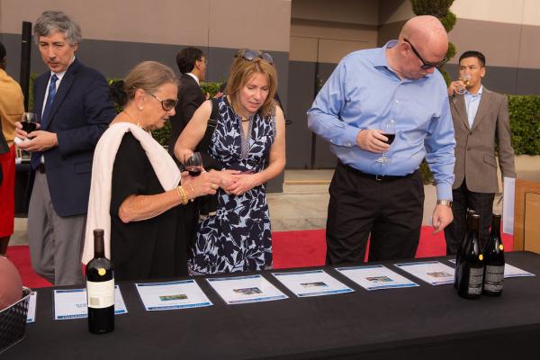 Attendees at Spirit of Innovation Gala 2018 looking at auction items